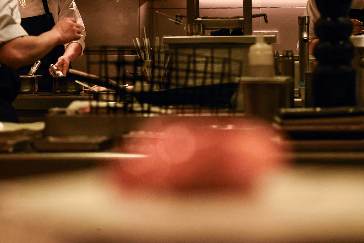 Chefs preparing food in a busy restaurant kitchen
