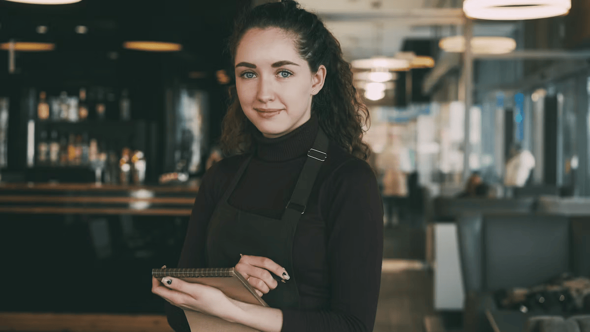 Service staff taking a customer's order on a tablet at the table
